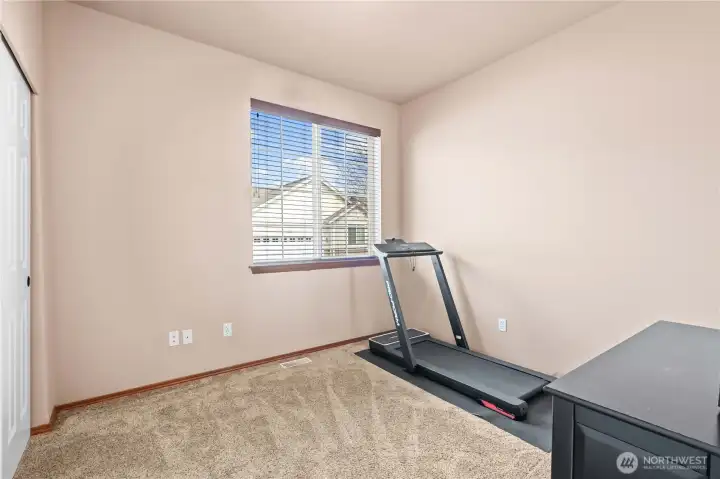 One of three spacious bedrooms, office, or workout room