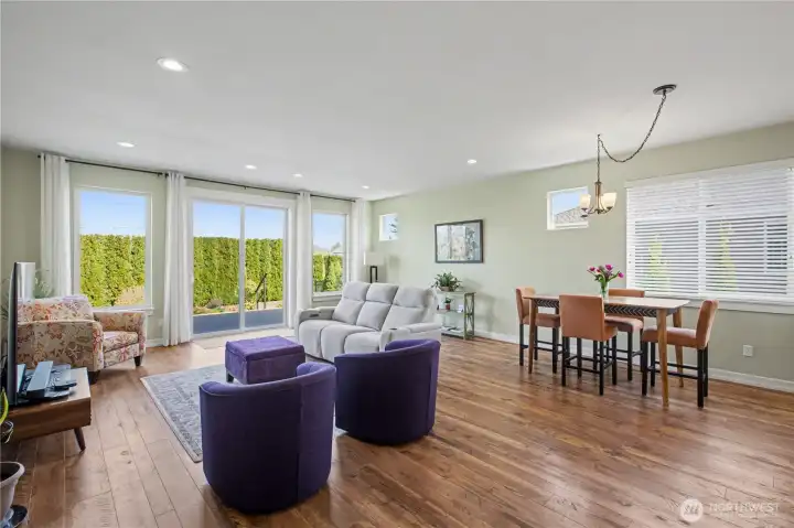 Newer Milgard sliding glass door and large windows that lead to the newer deck with composite decking. (There was a fire place but it was replace with slider for more light in the home). There is also plenty of room for your dining room table!