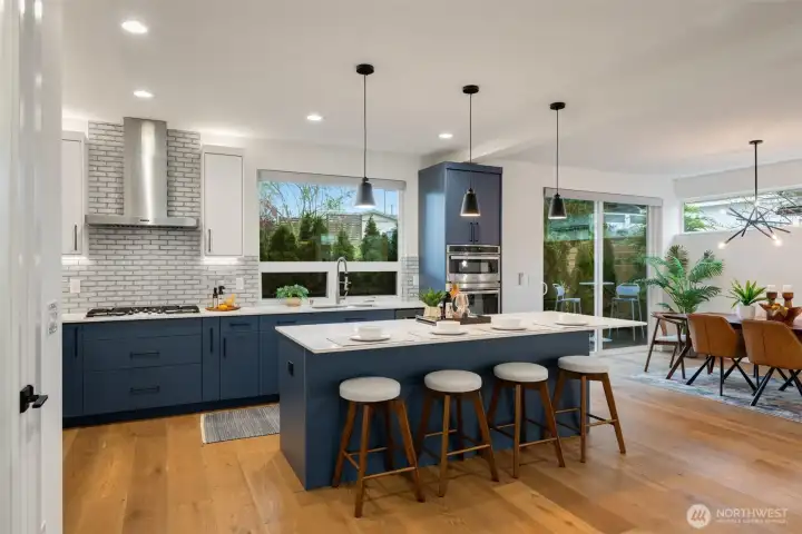 Giant island, stainless venting hood, gas cooktop, GE convection oven/microwave plus wall oven.