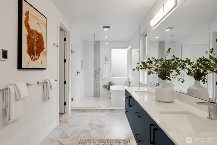 A true spa like experience in the 5-piece bath. Double sinks, quartz counters and beautiful, heated stone tile floors. A full wet room with soaking tub+ rain shower.