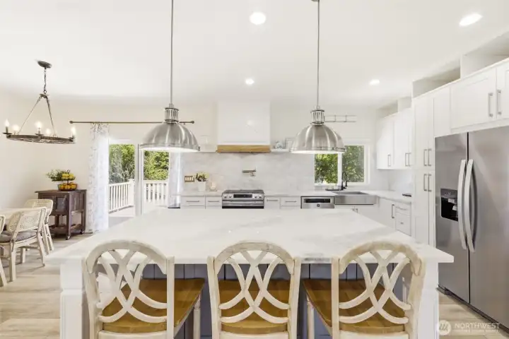 Updated kitchen with large island, bar seating + dining area.