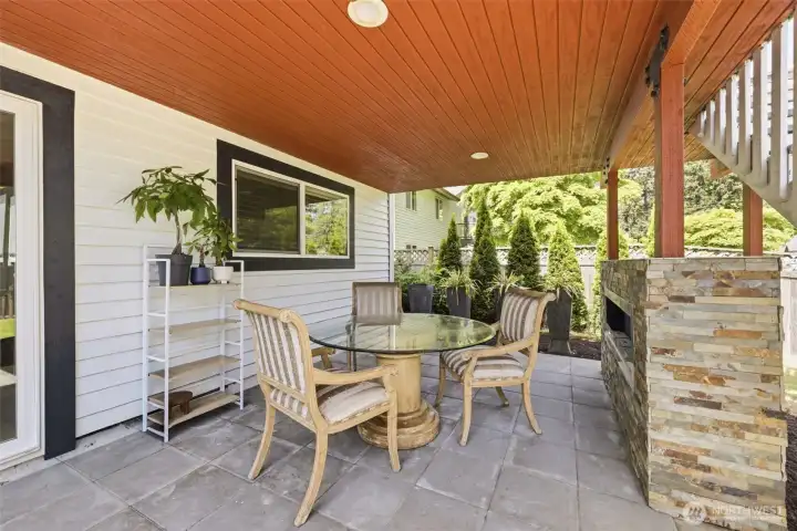 Covered patio with fireplace off the bottom floor entrance.