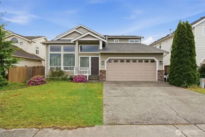 The beautiful front of the house features stunning curb appeal and a spacious driveway with plenty of room for parking.