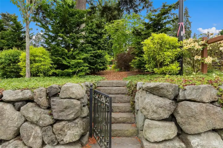 This is the gated entry off the Ericksen Avenue side walk leading to the private gardens planted for the homeowners of Ericksen Garden.  (To the left is the cutest little Lending Library alcove.)
