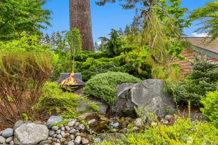 Another angle of the firepit gathering area, the water feature, beautiful granite boulders and the dry riverbed.