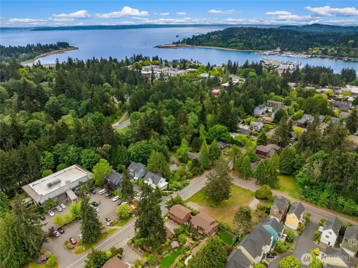 The Ferry Terminal  is straight ahead in Eagle Harbor and the Carriage House Building for sale is the smaller of the two brown buildings in the lower middle.