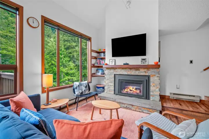 Comfortable living room for gatherings, letting the outdoors in through large picturesque window view.