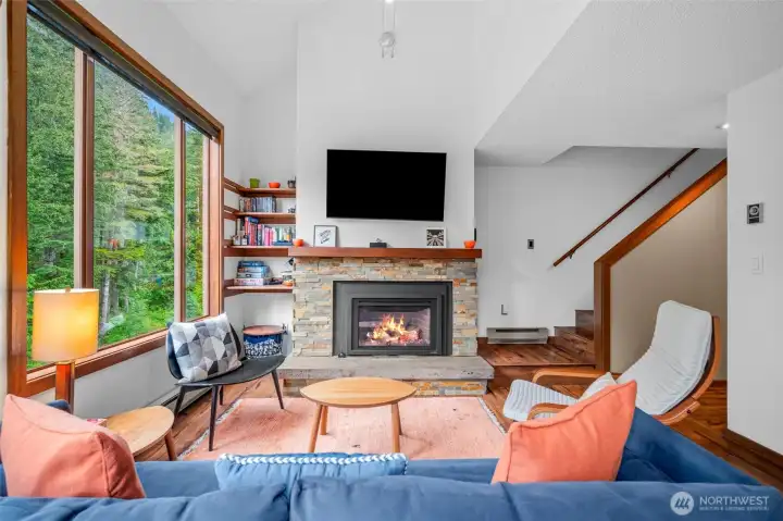 Decorative rock surround for gas fireplace with low cement seating.