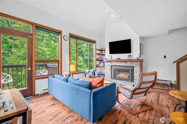 Large windows open up to the view of the foothills and door to the balcony.