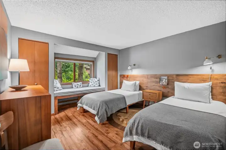 Lower level bedroom has a reading nook under the large window.  Two closets.