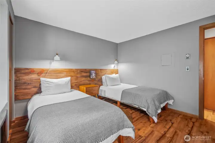 Lower level bedroom with two beds.