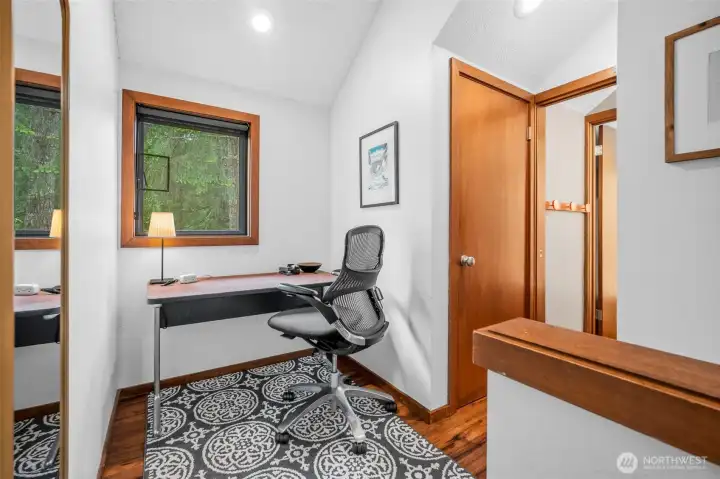 At the top of the stairs is a little office area with window to the outside.