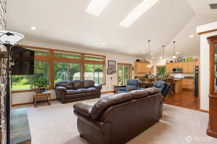 Great room with skylights, wood wrapped windows and vaulted ceilings.  Warm woods and stone all throughout.