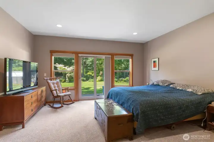 Primary bedroom with slider out to back patio. Lovely territorial views into the gardens.