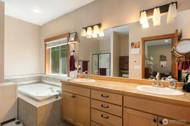 Primary bath with jetted tub, dual vanity and large walk in closet.