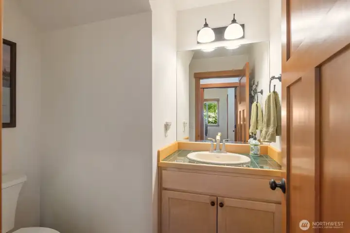 Powder room off of the kitchen by the garage entrance.
