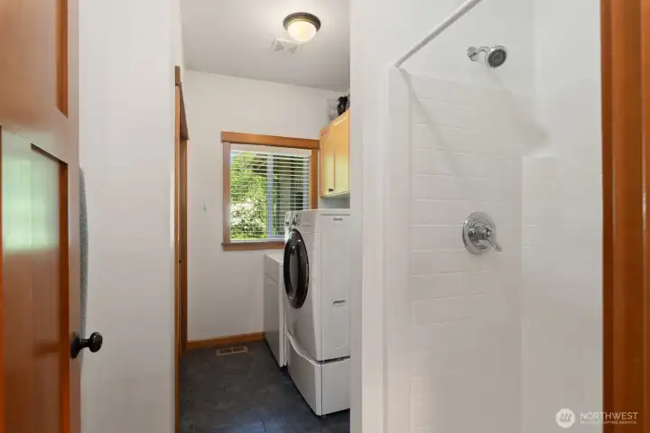 Laundry room has a utility sink and a shower. Perfect from coming in from the garden or shop.