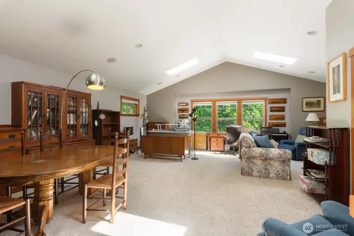 Huge bonus room up with vaulted ceilings and more skylights.  Half bath to the right of the picture.