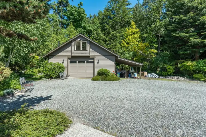 Shop with loft and carport. Wood stove in shop for heat.