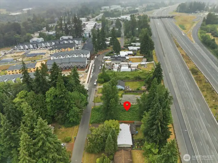Drone view showing property with 164th bridge in the background. Property sits high above 1-5