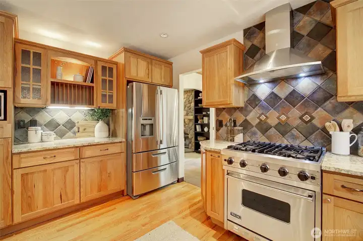 Gourmet kitchen has pantry, appliance garage and many work areas with easy flow between them.
