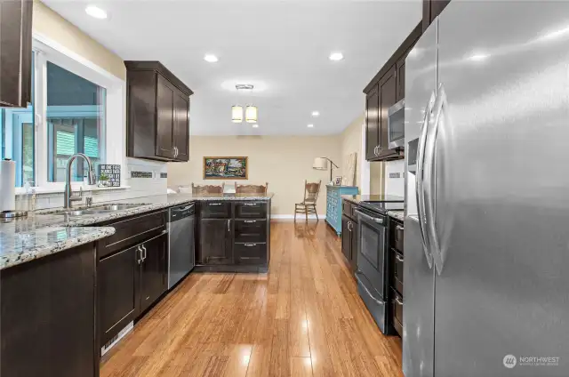 Granite Counters, walnut Cabinets, Bamboo floors, stainless steel appliances, breakfast bar, and a window above the double sink- everything you need!