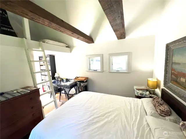 Vaulted ceilings with large, reclaimed beams. Ladder to a storage loft