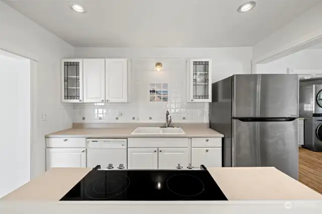 Custom backsplash and cute cabinetry.