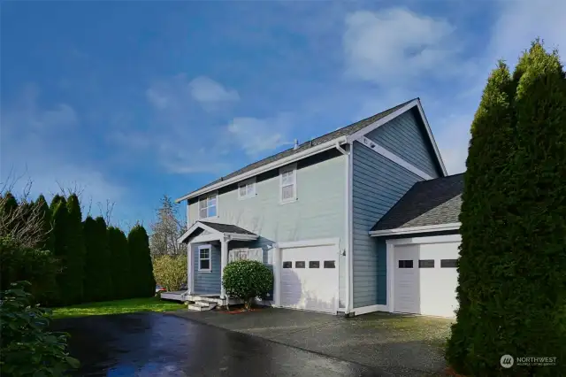 Back of home with access to the two-car attached garage.