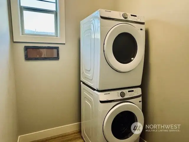 Laundry room offers full size stacking washer/dryer