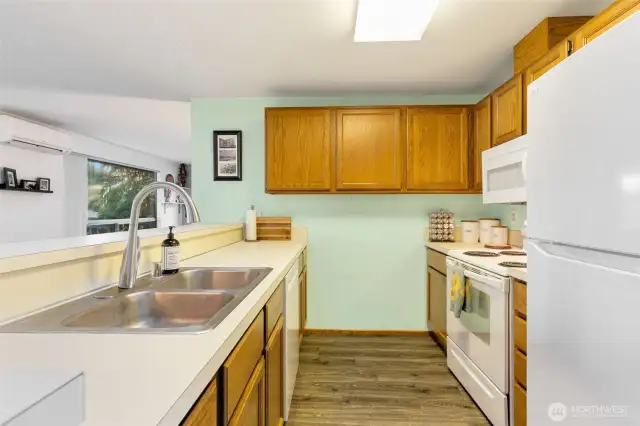 Wood cabinets in the spacious kitchen, lots of counter space, and newer appliances stay!