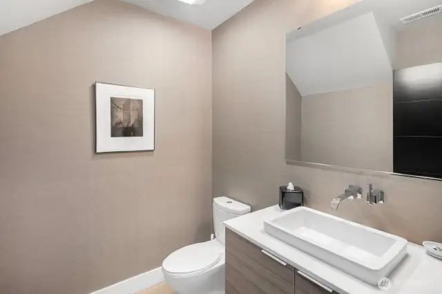 The main floor powder room continues the clean lines and fine finishes