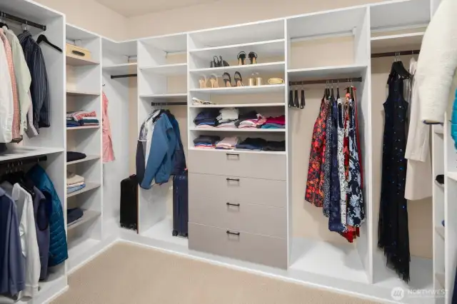 A spacious walk-in closet with custom built-ins means preparing for the day and night is always within easy reach