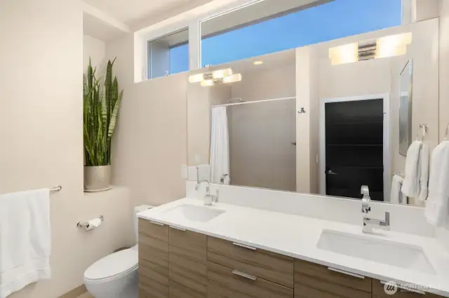 The luxurious full bath is perfectly located between the additional two, upper floor bedrooms down the hall from the primary suite