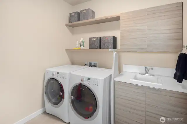 The laundry room continues the cohesive look and smart design that define this beautiful home