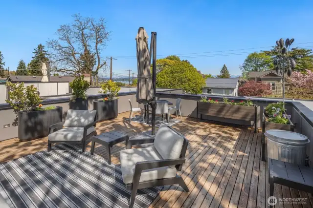 With room to entertain, garden, bask in the sun or take in a sunset, here is a second angle of the huge rooftop deck, looking northeast, showing a view towards Lake Union and the Cascade Mountains