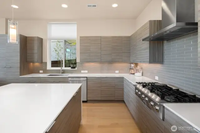 It's easy to make cuisine your fluent love language with custom cabinets, a sea of white quartz and high-end, stainless appliances including an Electrolux 6-burner gas cooktop
