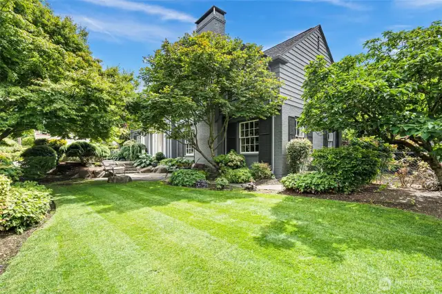 Lovely gardens surround the home on this corner lot.