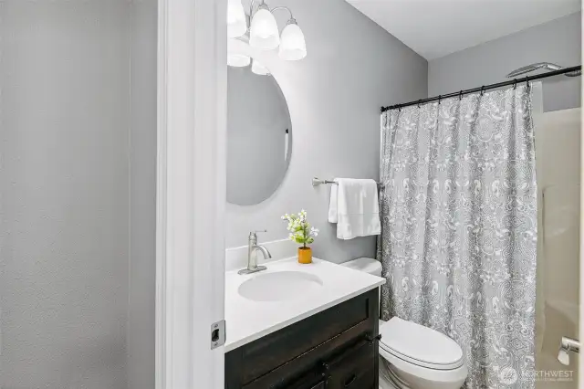 Remodeled four piece bathroom with chrome fixtures throughout.