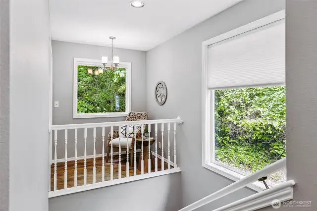 Open stairwell, with sitting area that extends off of bedroom.