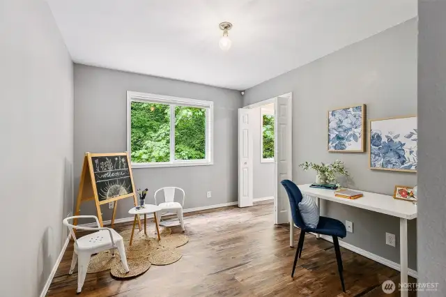 Secondary bedroom with closet. Additional doors open to stairwell with platform sitting area.