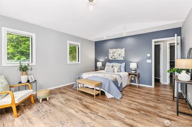 Large primary suite with additional space for indoor seating area.