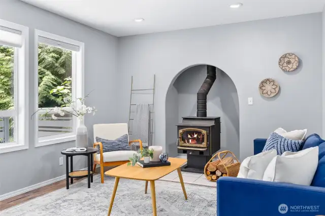 The alcove housing the stove is a cozy architectural feature, adding charm to the space while staying warm year-round.
