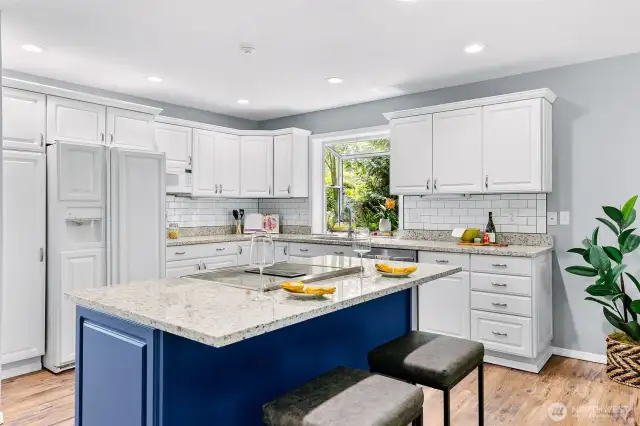 Updated kitchen with stainless steel appliances, side-by-side refrigerator and granite countertops. Bar stool countertop offers in-kitchen eating for two.