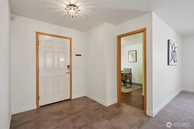 The entry with new vinyl floors, looking into the 3rd bedroom