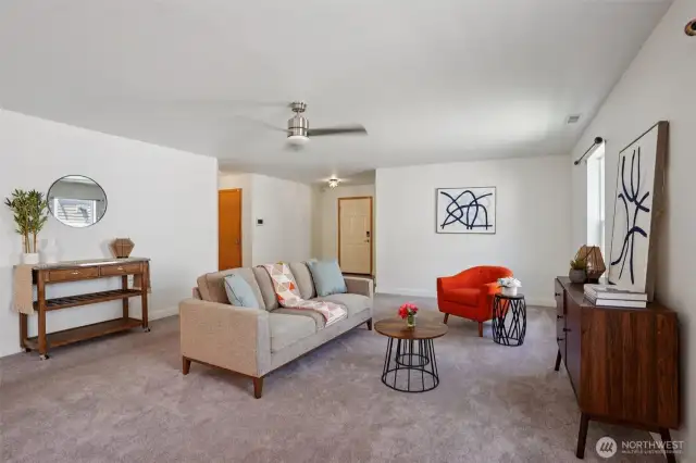 Looking from the dining room to the entry and garage to the left. Office/3rd bedroom is to the right