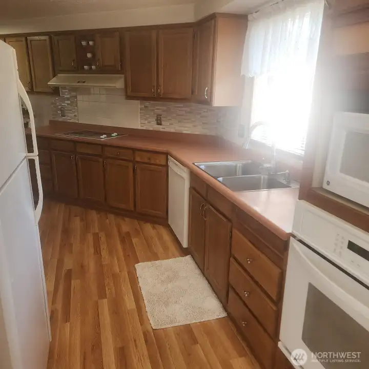 View from dining room entry to kitchen. All appliances stay.