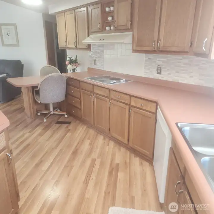 Plenty of cabinets and island seating at end of kitchen.
