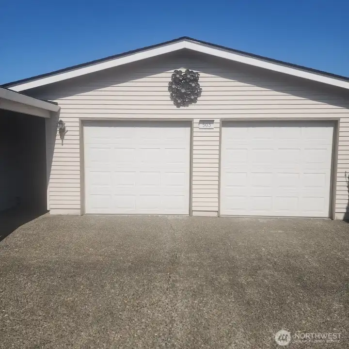 Standing tall, two car garage with openers. Garage and home have newer roof and gutters.
