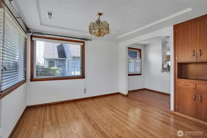 Dining room with a peak into the kitchen eating space, don't miss the original built ins!